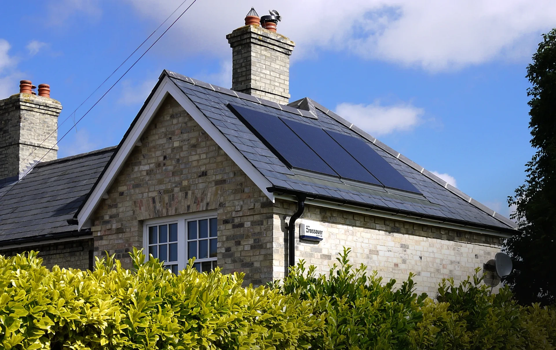 Gabled brick cottage with rooftop solar array